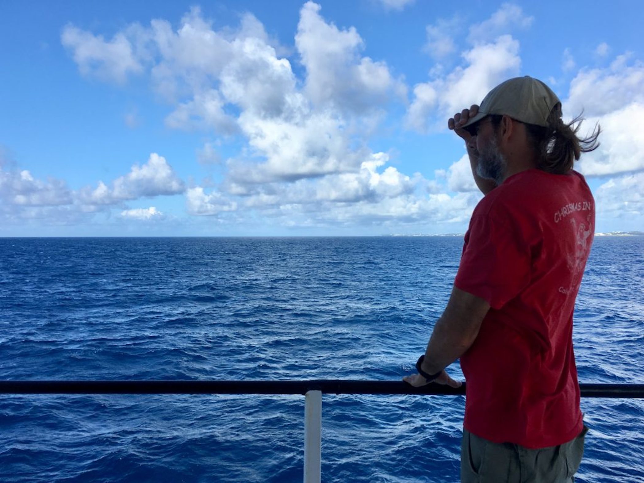 Scientist Michael Gonsior on deck of research vessel looking out onto the deep Atlantic Ocean